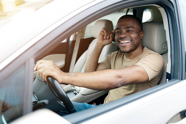 istock Confident African American man smiling while sitting in drivers seat, 2228307100