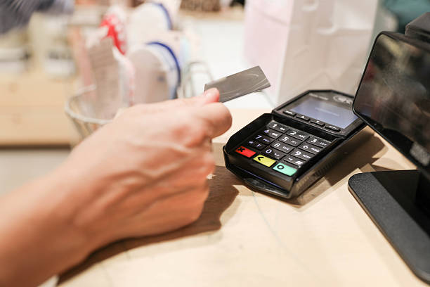 istock Credit Card Hovering Above Terminal for Contactless Purchase 2228308201