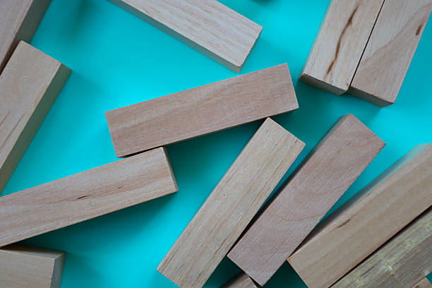 istock An abstract pattern of chaotically scattered wooden blocks on a turquoise background. This vibrant composition creates a sense of dynamism and creative chaos, making it perfect for use in design, website layouts, advertising materials, and print. 2228314317