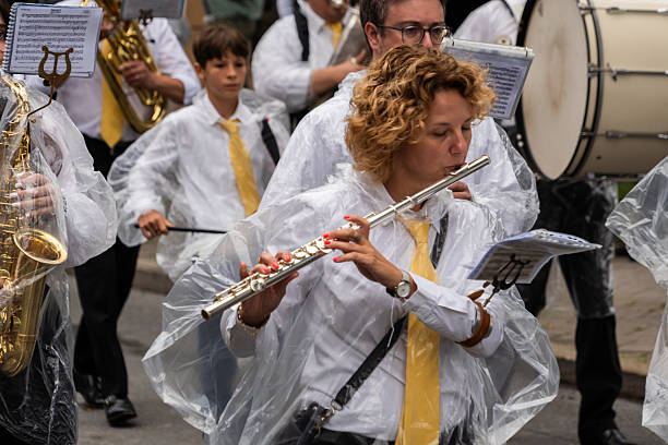 Villach, Austria - August 2nd, 2025: Close-up of Musician withstanding the rain at the procession of the 80th 'Villacher Kirchtag', the largest traditional folk festival in Austria.