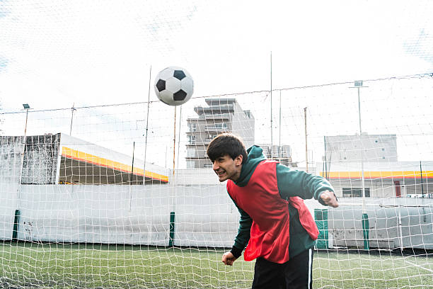 istock Soccer player hitting the ball with a header on the field 2228314910