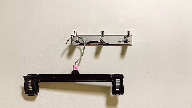 istock An empty clothes hanger hanging on the wall in a fitting room 2228315858