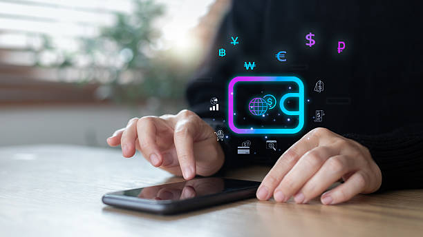 istock Hands using a smartphone with a digital wallet icon and global currency symbols. Concepts of mobile payment, fintech, online finance, and international money transactions. 2228317897