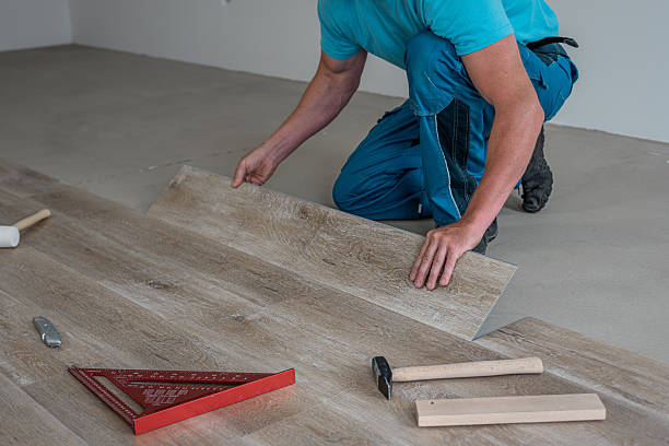 istock Floating floor work. The worker inserts the board of vinyl plank to the click system of Floating floor. 2228319075