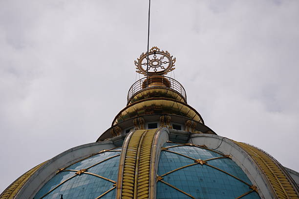 Ornate Blue-Green Dome with Golden Crown Finial on Historic Building