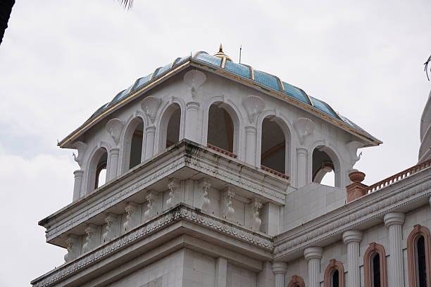 White Classical Tower with Teal Dome, Arched Windows, and Ornate Columns