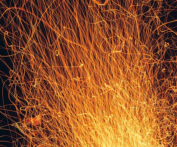 Barcelona, Spain - 09/21/2024 Celebration of the autumn equinox or end of summer, Correfoc.\nDynamic long exposure of fireworks creating vibrant trails and sparks on a dark night in Carrer de Gracia.