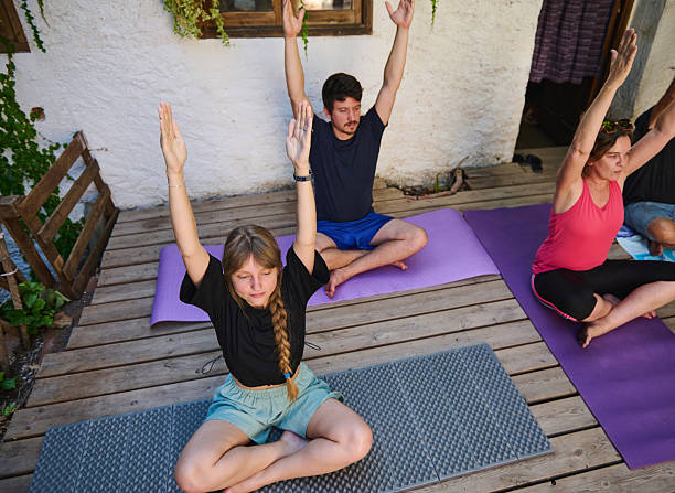 istock Group Yoga Practice Outdoors on a Wooden Deck 2228323974