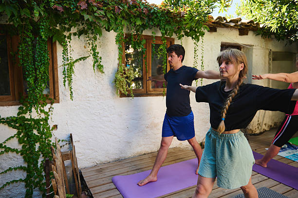 istock Individuals Practicing Yoga Poses Outdoors at a Scenic Retreat 2228324372