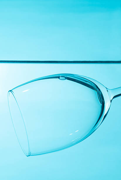 istock Glass in water  isolated on blue background. 2228326131