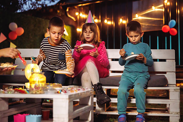istock Children eating birthday cake at a party 2228326828