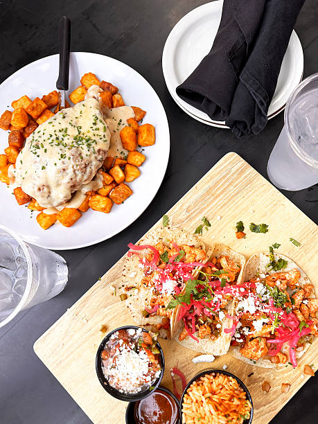 Mexican Tacos with Sauces and Chicken Parmesan Dish. Top View