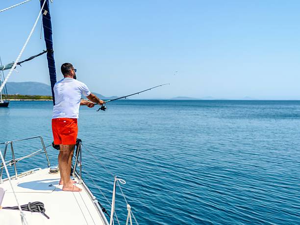 istock Man fishing on a boat 2228328834