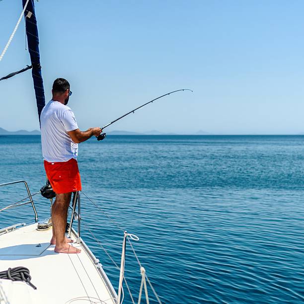 istock Man fishing on a boat 2228329419