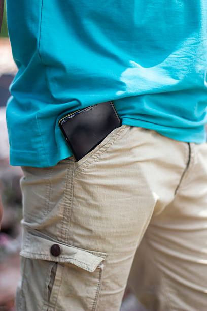 istock A man holds a mobile phone with his pocket 2228334297