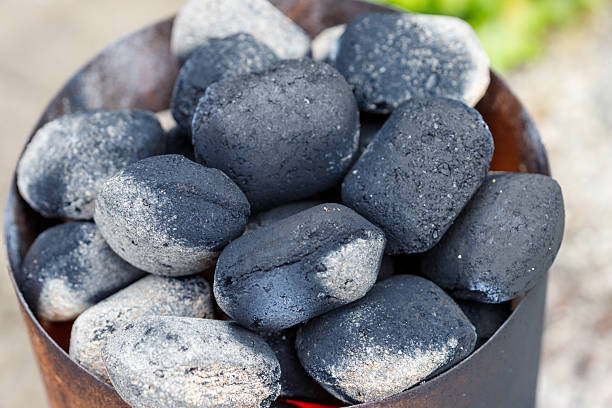 istock Charcoal Briquettes in a Metal Container 2228334322