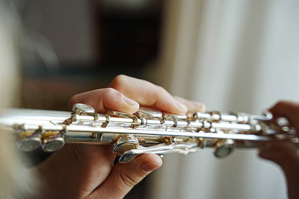 istock Close-up of Hands Playing Flute with Precision 2228334397