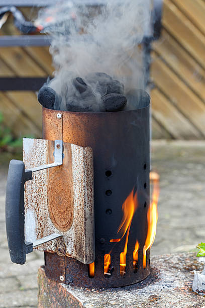 istock Charcoal Chimney Starter with Flames and Smoke 2228334408