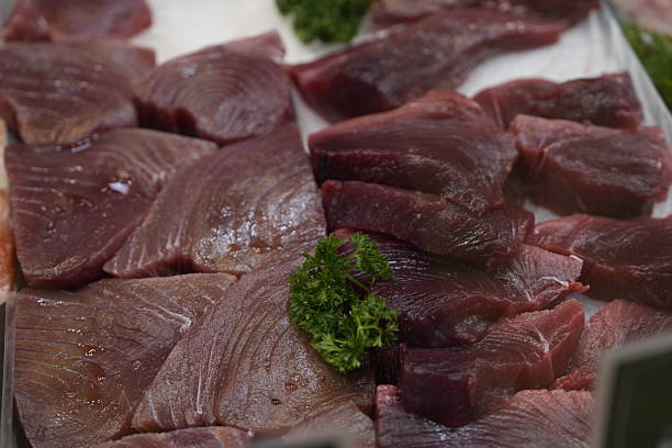 istock Fresh Raw Tuna Fillets on Ice Display at Market 2228334456