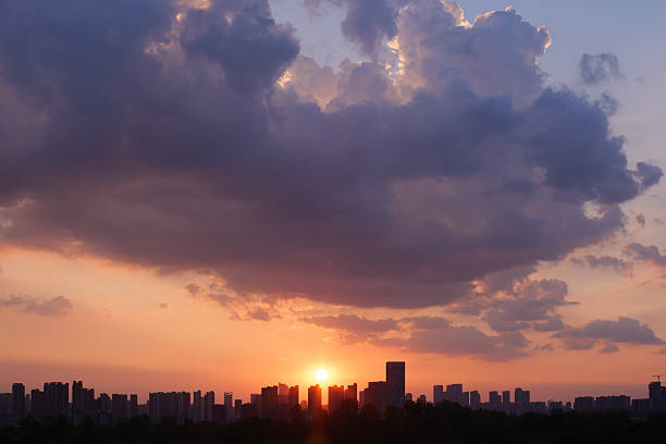 Captured in Wuhan during a warm August evening around 7 PM, this photo features vibrant orange clouds and a soft gradient sky at sunset. The dramatic cloudscape and peaceful summer atmosphere evoke serenity, making it ideal for nature, weather, or seasonal visuals.
