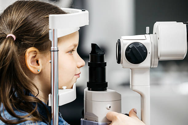 istock Child undergoing vision testing with advanced ophthalmic equipment, focused on eye examination process 2228335534