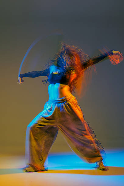 istock Expressive Jazz Funk Dancer in Motion with Vibrant Lighting and Dynamic Modern Choreography 2228337583