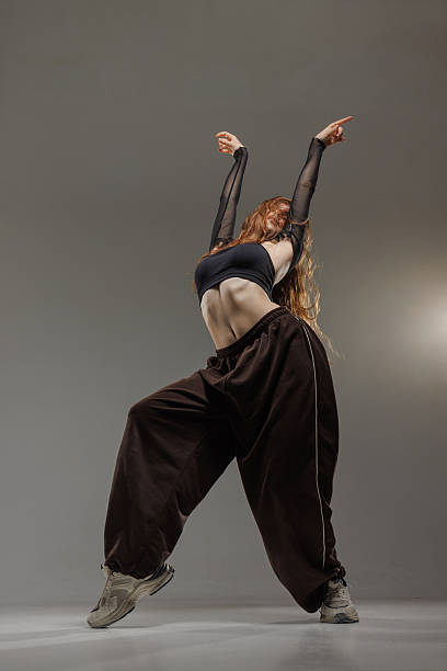 istock Confident Jazz Funk Dancer Striking a Dynamic Modern Pose in Trendy Urban Studio Setting 2228337610