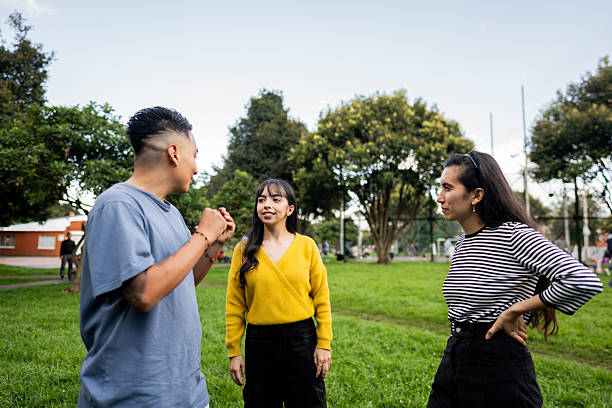 istock Young friends talking at public park 2228337882