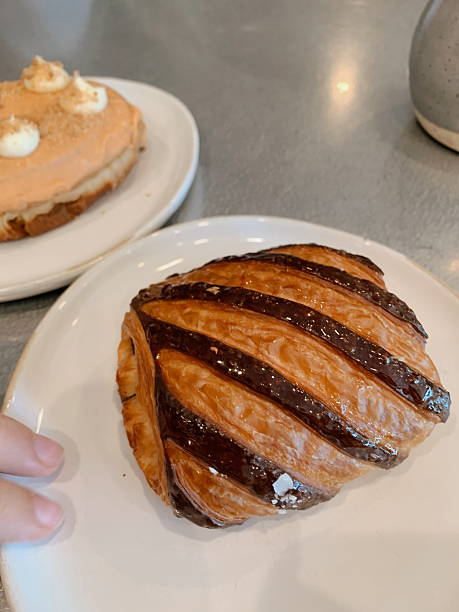 A Striped Raspberry Chocolate Croissant & a Guava Doughnut in a Local Coffee Shop in Sunny West Palm Beach, Florida, in August of 2025