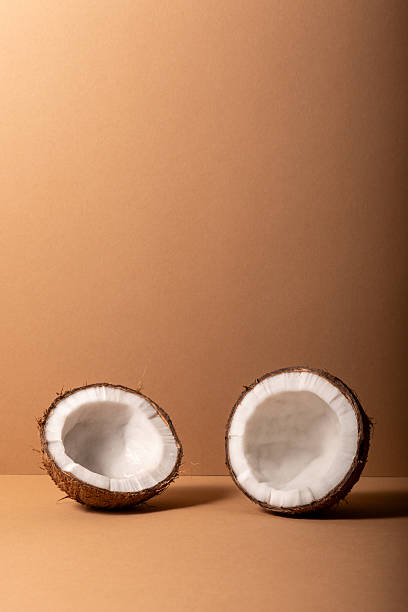 Cracked coconut on bright background. Summer tropical concept.