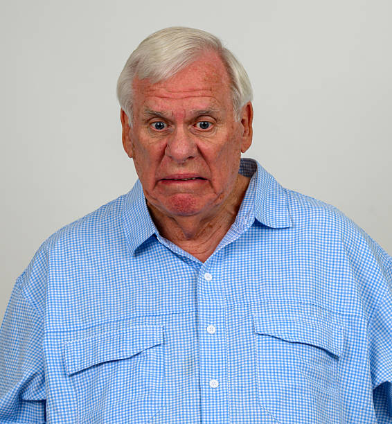 istock Older man looking down with look of disgust on his face 2228340093