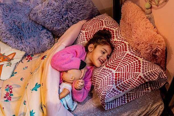 Child girl lying on bed at home - Girl with Cerebral palsy, NECN (Non-Evolutionary Chronic Encephalopathy) - Non-Progressive Encephalopathy.