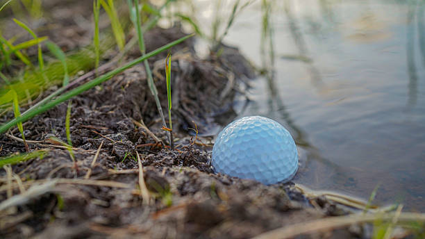 istock Problems and obstacles of Golf balls are in danger from water. White golf ball falls into the water one of the obstacles to playing golf 2228341721