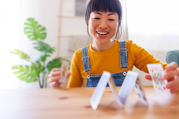 istock Woman playing card games while relaxing at home 2228342434