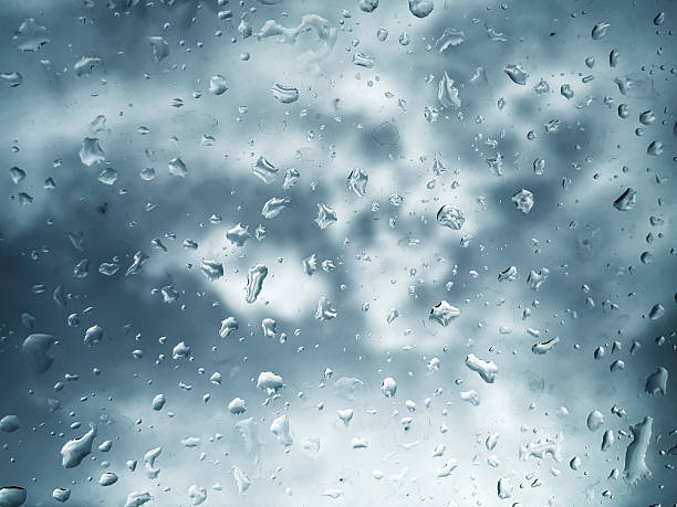 Moody Raindrops on a Window with a Stormy Sky Background