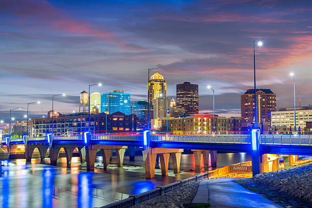 Des Moines, Iowa, USA downtown cityscape on the river at twilight.