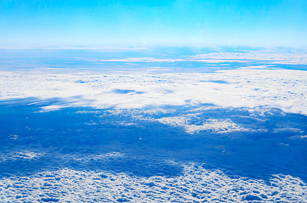 Dense cumulus clouds covering bright blue sky creating stunning natural skyscape scene