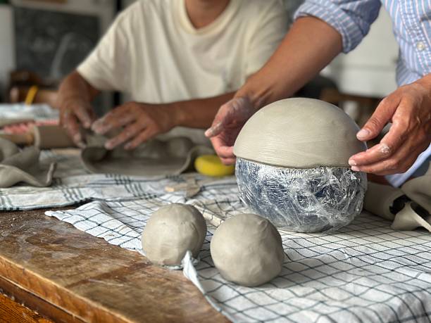 istock Hands crafting ceramic bowl in natural light – handmade pottery making close-up 2228345749