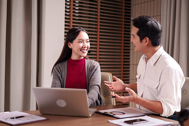 istock Asian adult business professionals discuss work ideas collaborate on project using laptop headset in modern office boardroom interactive meeting 2228350706