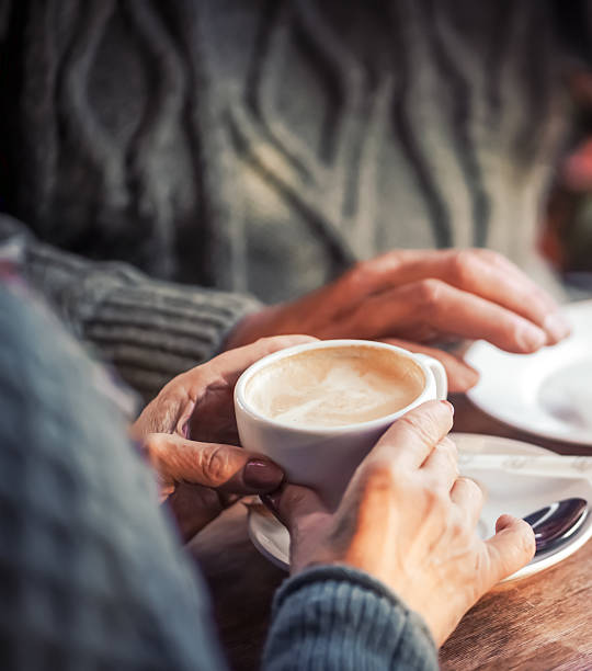 istock An elderly couple drinking morning coffee with croissants. 2228351938