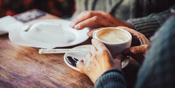 istock An elderly couple drinking morning coffee with croissants. 2228352843