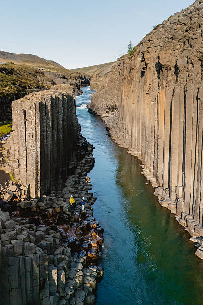 istock Majestic Studlagil Canyon featuring unique basalt columns and a serene river view 2228353328
