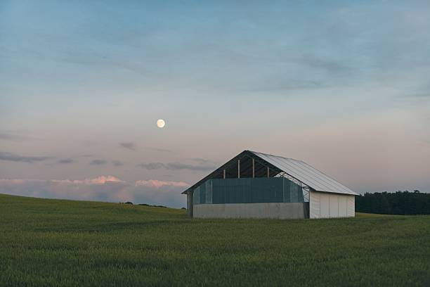 istock Modern Barn Under Full Moon in Rural Field 2228354396