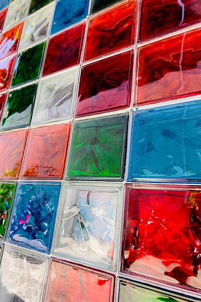istock A vibrant mosaic wall made from multi-colored glass blocks arranged in a diagonal grid. Each square glass tile has a shiny, liquid-like surface. 2228355500