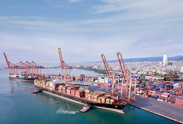 istock Aerial view of Cargo Container Ship approaching port with tugboat. 2228366234
