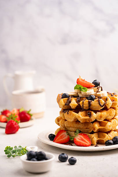 istock Tasty Belgian waffles with fresh berries 2228376408