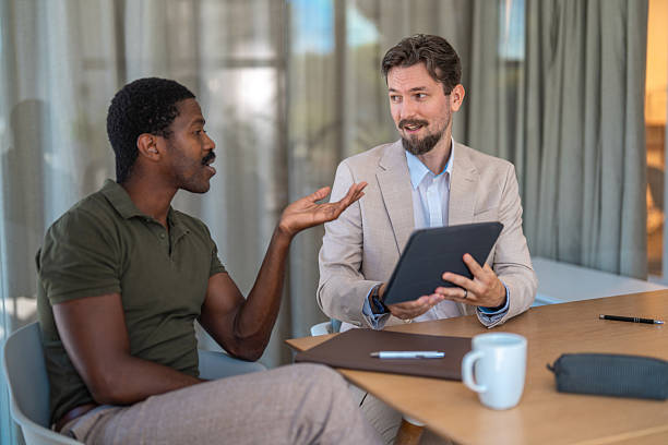 istock Confident Businessmen Discussing Strategies in Modern Office Environment 2228377003