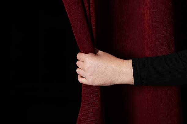 istock Woman opening red front curtains in theatre, closeup. Space for text 2228381507