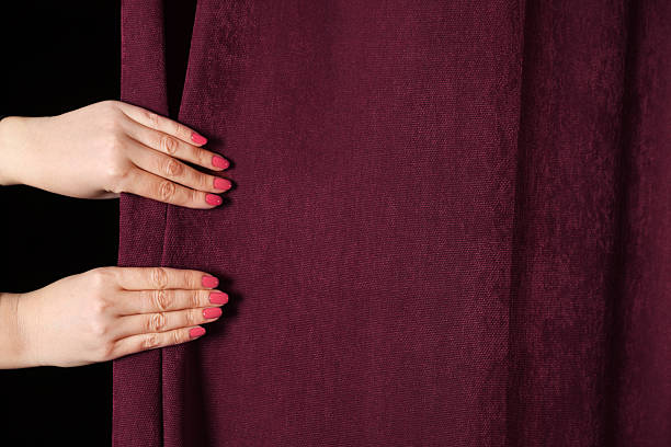 istock Woman closing red front curtains in theatre, closeup 2228381538