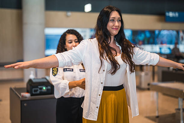 istock Young Hispanic Female Airport Security Worker Scanning Passenger in Brightly Lit Modern Terminal 2228382705
